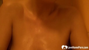 Horny chick plays with her pussy while showering