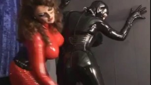 Latex Lesbian Girls Fucking - Dominant lesbian in latex red suit strap fucks submissive girl and rides  her face, uploaded by nese02