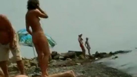 Erotic nude beach video of a couple carresing each other