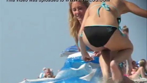 Beautiful busty blonde teen in bikini at the beach, candid boobs