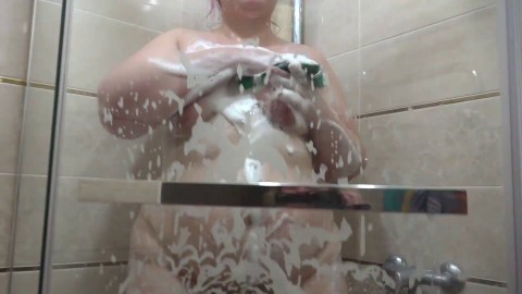 BBW with big booty in soapy foam masturbates in the shower. Milestone rubs her hairy pussy to orgasm.