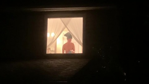 Voyeur watches sexy neighbor through window after shower