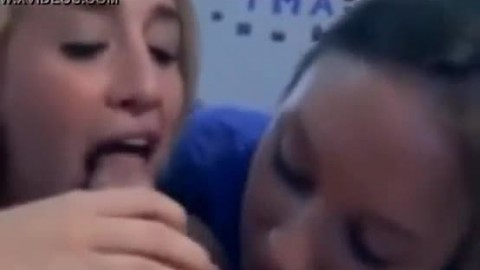 Two girls give a blowjob to their friend