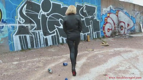 Sexy girl in a leather jacket and leggings shows her ass