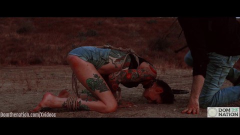 Ass eating bondage slave cries while her feet get caned outdoors in the dirt - Rocky Emerson