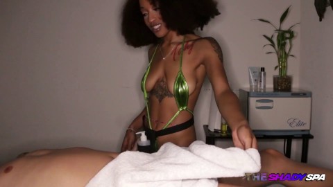 Inked ebony masseuse wanking dick during erotic massage
