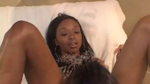 Young ebony and horny brunette lick each other's pussy in bed