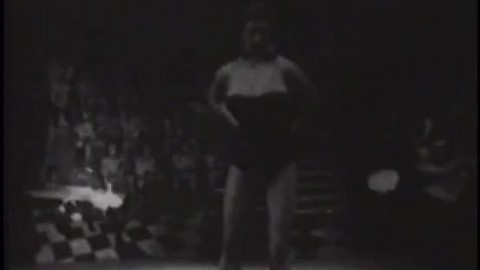 Lustful brunette with huge jugs strips and dances on the stage of the old circus