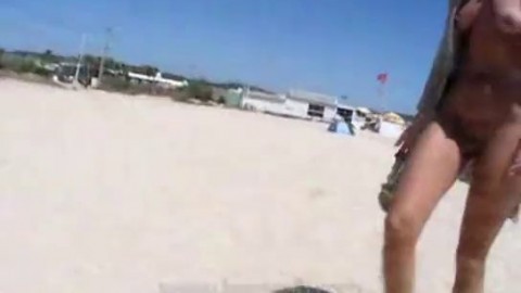 Woman walks naked around beach