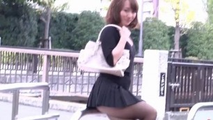 Japanese woman in a short skirt with high heels sitting on the street