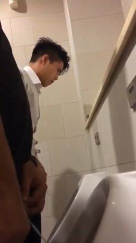 A male is pissing in the toilet 27.