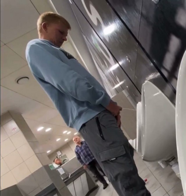 A male student is pissing in the toilet 8.