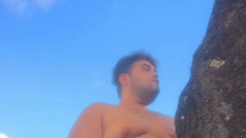 young chubby guy goes to the beach to masturbate and caress his giant breasts