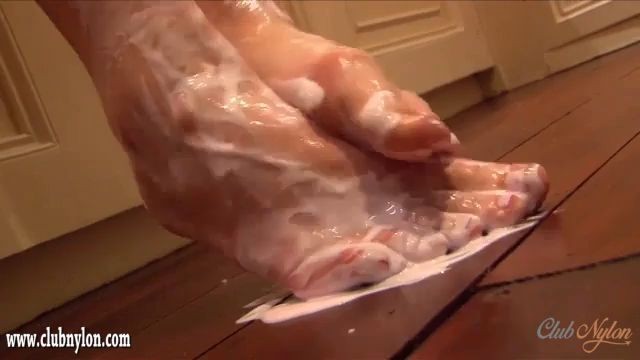 Curvy brunette Paige Turnah rips her nylon pantyhose and creams her sexy feet and wet pussy